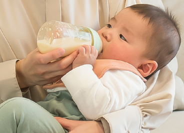 baby drinking milk from a bottle